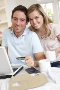 happy couple about to pay with credit card online