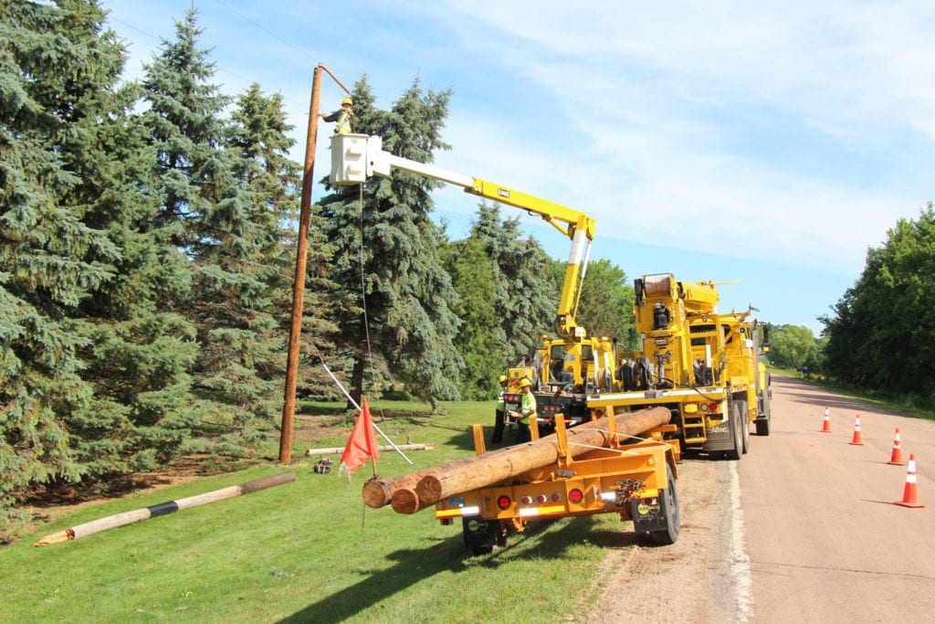 workers putting up power pole