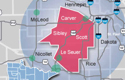 A map highlighting Carver, Sibley, Scott, and Le Sueur counties in red, with nearby counties labeled and major highways including I-35 and I-494 visible. Green dots mark several locations within and around the highlighted area.