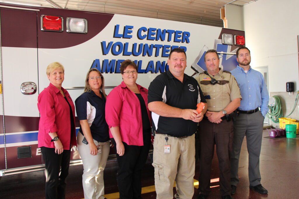 Le Center Ambulance tourniquet kits with people in front of truck