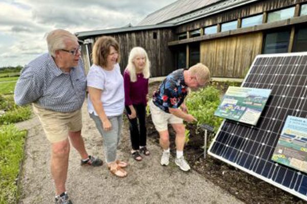 U of M Landscape Arboretum solar display with people