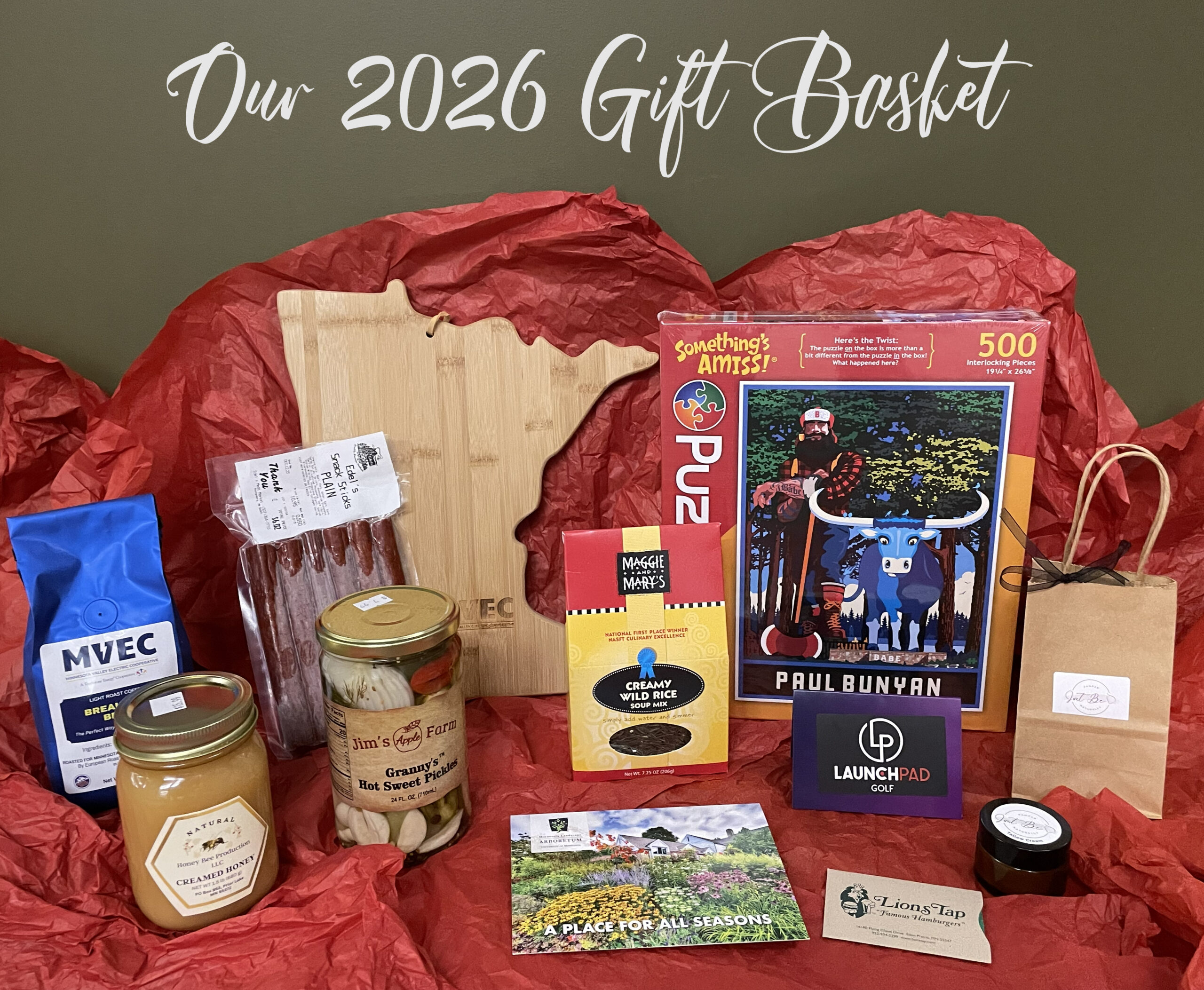 Gift Basket products include gift cards, food items, puzzle, cutting board and more.